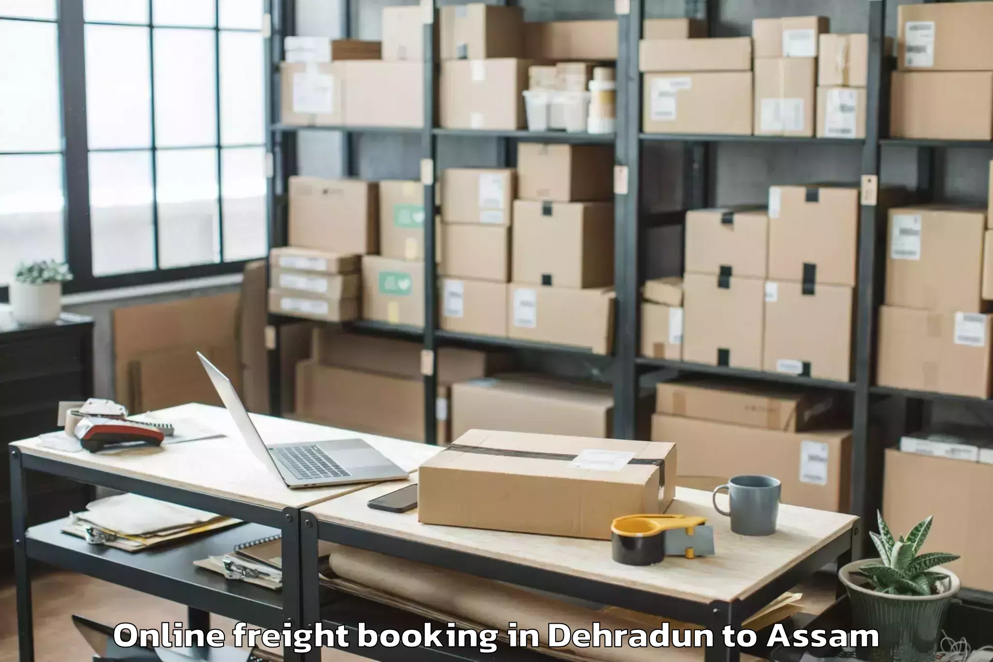 Book Dehradun to Salonibari Airport Tez Online Freight Booking Online